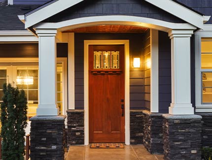 front entry door with sidelights and covered porch