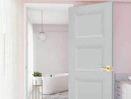 white interior door opening into a bright bathroom or living space