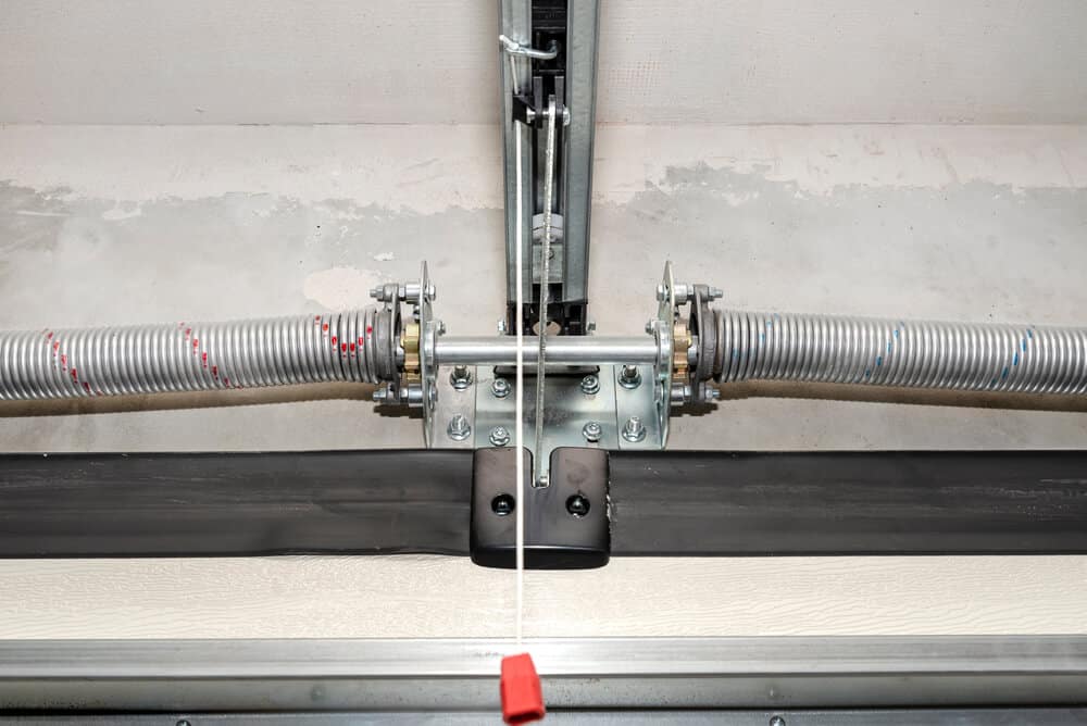 close-up of torsion spring system above garage door