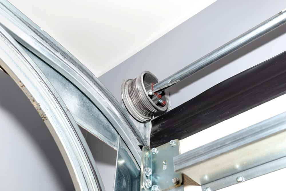 close-up of garage door cable drum and torsion spring hardware